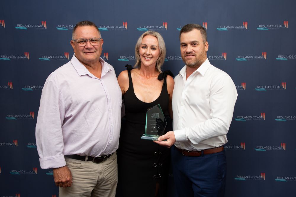 Directors Chris and Darren, receiving award from Rebecca Young, LNP for Redlands