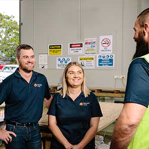 Three staff talking to trainer in Training Centre